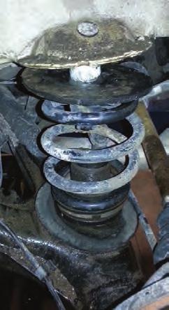 Remove the coil spring and spring pads from the vehicle (fig. 5).