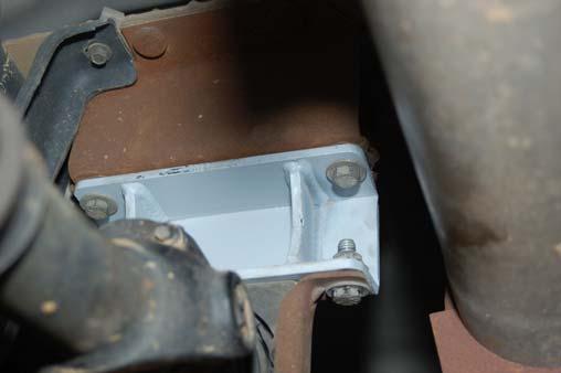 The bracket is installed with the tall part of the bracket toward the rear.