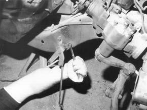 Disconnect the transmission linkage bracket from the