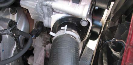Use a 10mm socket to remove the bolt that secures the power steering