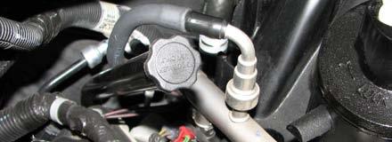 Use a 3/8 Fuel Line Removal Tool to disconnect the fuel line from the passenger side fuel rail. 60.
