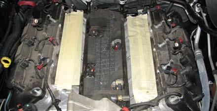 Use a 10mm socket to remove the two bolts securing each ignition coil, then pull them out.
