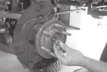 Install the three IWE actuator to wheel knuckle retaining bolts; torque to 106 ft-lbs Remove the IWE vacuum cap and reconnect the vacuum tubes.