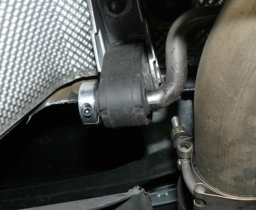Step 4 Once the exhaust system is properly adjusted, install a hanger post clamp on each of the rear muffler hanger posts, as shown at arrow in Figure 4.