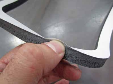 x. Remove the waxed paper backing from the silicone foam window gasket (5-1060) by pinching the gasket on its sides, then pealing up the