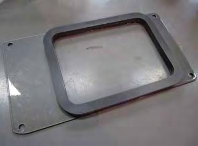 Place the powder coated airbox heat shield lid (20-8517) on a table with the part number stamp facing DOWNWARD.