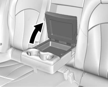 If equipped, there is a storage bin behind the cupholders in the rear armrest. Lift the cover to open.