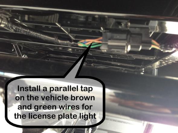 33. Locate the brown (12 V DC, taillight) and green (ground) wires leading to the rear taillight assembly and install a parallel tap connector on each wire and connect the red wire from the plate LED