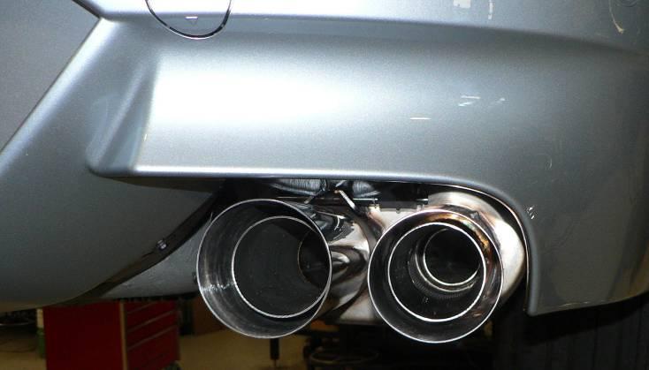 Secure the muffler by attaching the muffler hangers to the car.