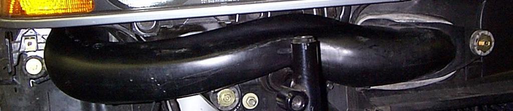 11. Remove the factory air box from the vehicle. Start by removing the 10mm head bolt securing the air box to the mounting bracket on the front right fender. 12.