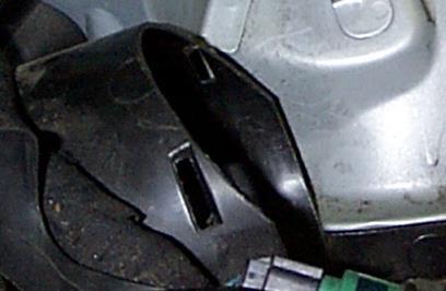 17. See Figure 7: Trim steel tray as shown in picture (the picture is of the metal tray under the passenger side front turn signal with the metal try already cut).