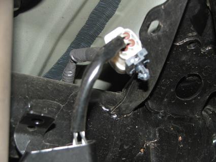 Remove upper 12mm bolt holding brake line bracket to frame tube on the driver side and remove ABS wire mounting bracket from the frame tube on passenger side