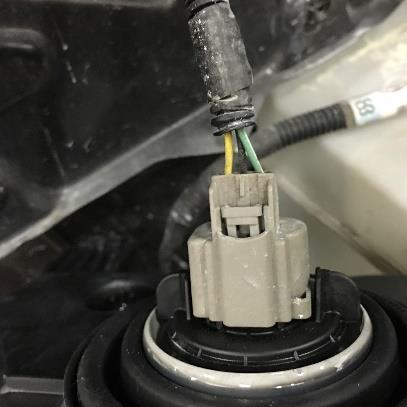 They cannot be installed on the wrong side. Hook up the electrical connector to the headlight bulb.