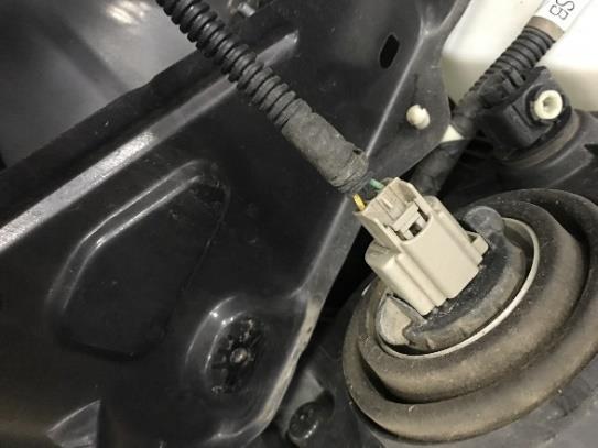 After the bolts and clip are removed, unhook the electrical connector, by pushing inward pressing the release tab, and pulling apart. 7. Remove the inner fender liners.