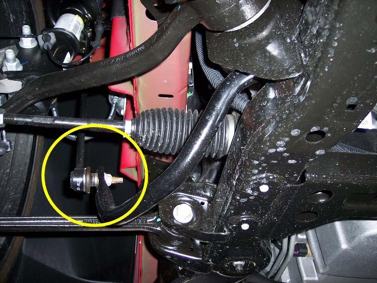 Remove the driver side front wheel to gain more clearance for