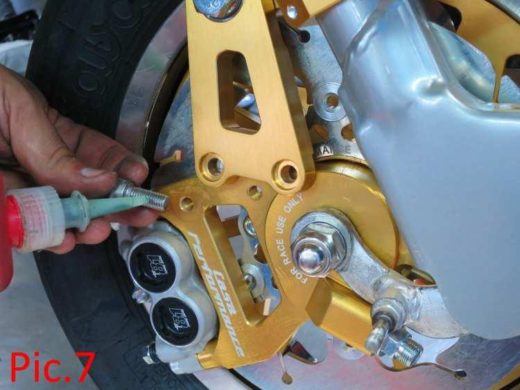 If it sit s to one side, use normal Lambretta axle washers (thick B118 or thin type B119), as necessary) by adding them to the axle before fitting the whole unit into the forks (so the washers sit