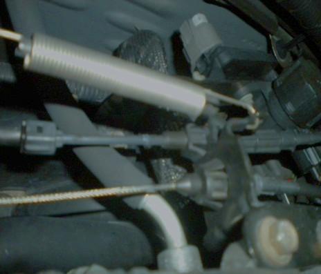 firewall. A. The throttle cable may be tricky as it curls up and under the guide on the throttle body.