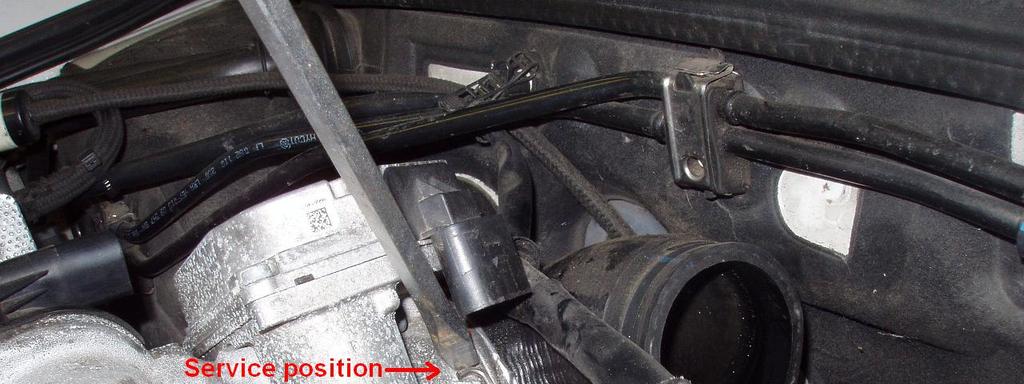 Loosen the elbow hose clamp and separate the rigid pipe from it.