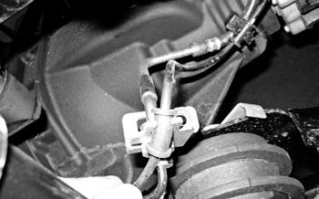 Unclip the wire harness from the front axle. 10.