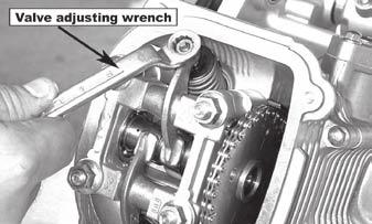 Turn the cooling fan clockwise until the mark of the timing drive sprocket on the camshaft is at the top, dead center, and the T symbol (or other mark) of the magneto flywheel aligns to the crankcase