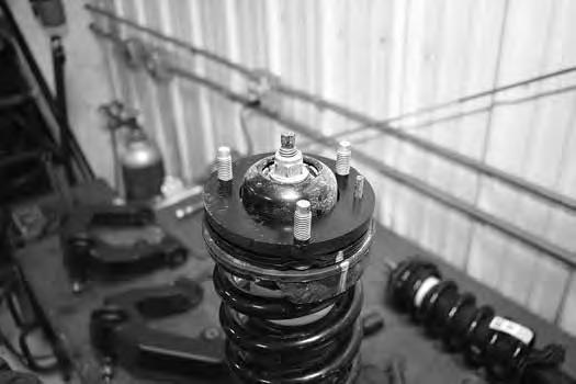 18. Reassemble the strut. Make sure to line up all of the alignment marks. Fasten the strut rod with the original nut. Torque nut to 35 ft-lbs.