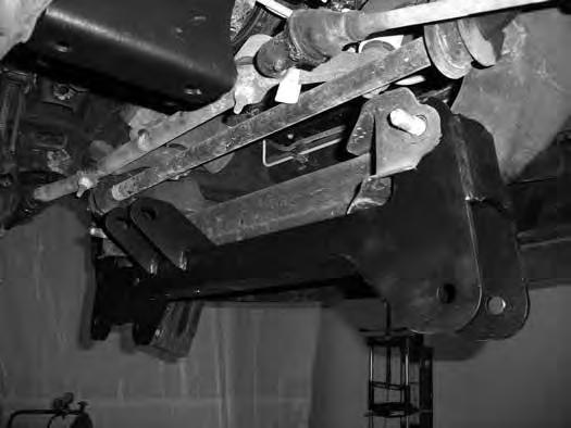 Figure 22 43. Using an appropriate jack, raise the differential up into the vehicle. Align the new driver's side differential bracket in the front crossmember mounting tabs.