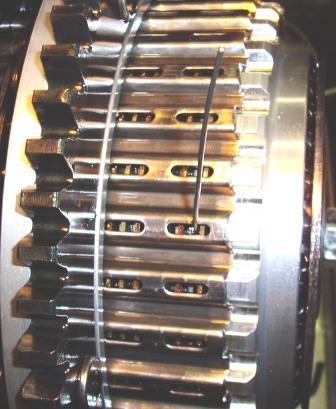 030 (smaller) set of wire gauges and insert them 180 degrees apart through the slots in the basket and between a drive plate and friction disk.