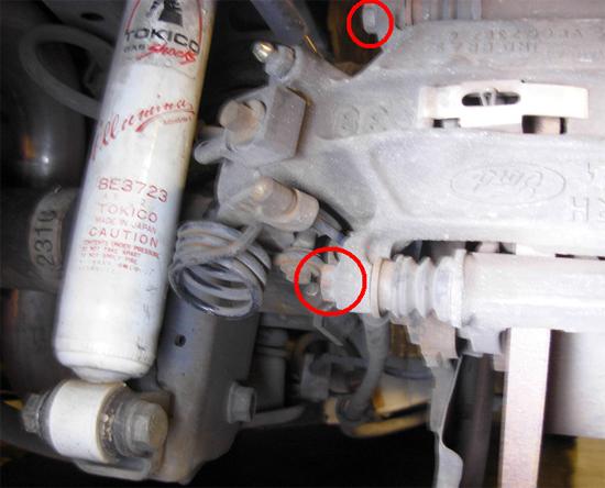 Wheel hub assembly. Caliper bolts circled in red. 23. Repeat these instructions for the driver side and then continue below*** 24.