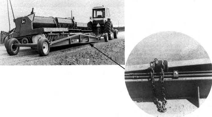 FIGURE 2. Doepker Transporter Loaded with Three Press Drills. FIGURE 3. Windrower Loading Ramps Showing Spacer Added to Increase Header Clearance.