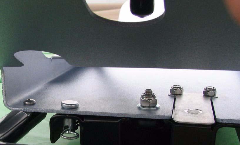 Insert and close the locking pin through the holes in the roof module and the mounting rail.