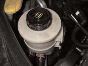 To do this, lift the cover slightly and pull it towards the inside of the engine (see Fig. 1).