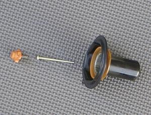 slide raises by counteracting the vacuum in the upper chamber The needle is held in by a clip or needle holder This needle holder has a spring that retains the needle but still allows for it to move