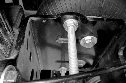 9. Use the long bolt, lock nuts and larger washers through the axle bracket and the long, two hole bracket to clamp the axle bracket to the leaf spring block.