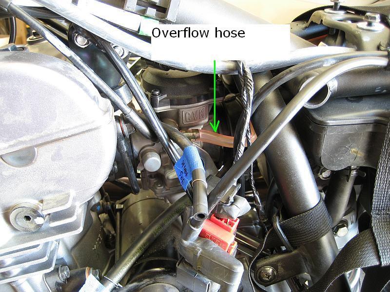 18 16) Next, remove the overflow hose from the other side (left) of the carb.