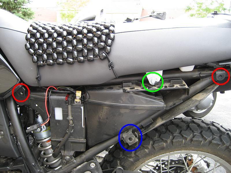 6 3) Take off the side covers, near below the seat, on each side. In the photo below, the red circles show the bolt locations that hold on the side cover.