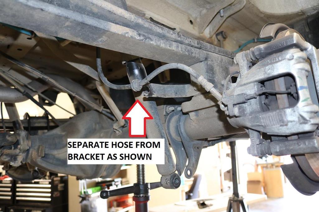Remove the U-bolts. See image below.
