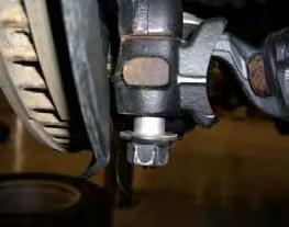 7. Using a 14mm wrench, loosen but do not remove the four upper strut