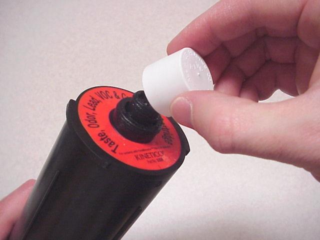 4. Remove the plastic wrapping from the filter cartridge. Remove the small plastic cap from the top of the filter cartridge (See Figure 5).