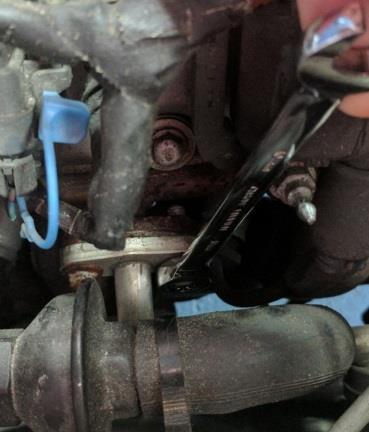 Remove bolts securing the valve cover to the head using a 10mm wrench or socket, extension, and ratchet (depending