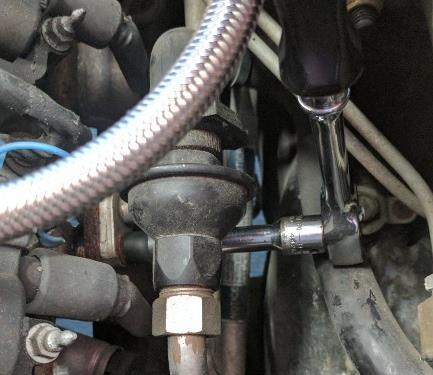 Remove the two bolts for the secondary air injection flange using a 10mm wrench or socket and ratchet.