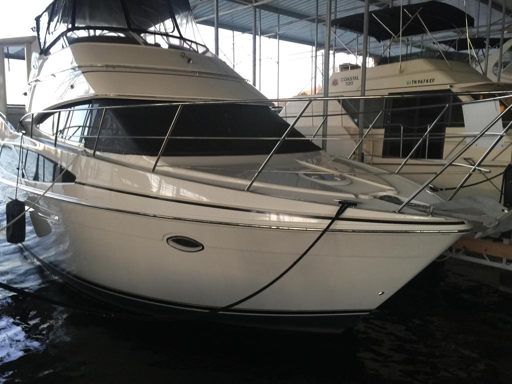 Aft deck includes built in seating, acrylic wing doors to walkways, and storage cabinet.