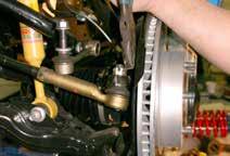 If suspension component contact or interference is present, lower the coil spring seat by lowering the coil spring seat retaining ring until no contact or interference is