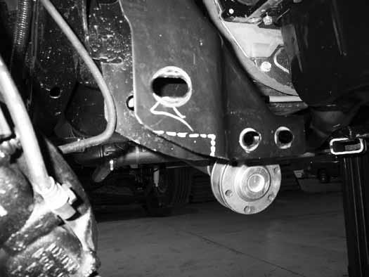 18. The factory rear control arm pockets must also be trimmed to clear the new rear crossmember. Measure down 1-3/4" from the center of the factory control arm slot and make a horizontal cut line.