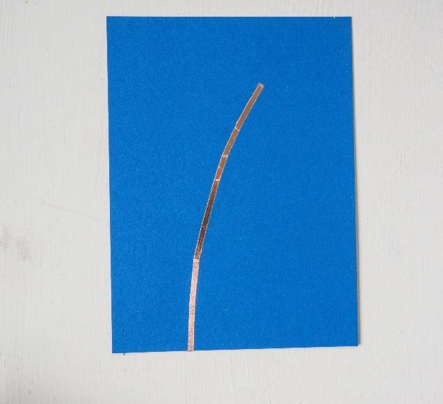 Fold the tape over the bottom of the card and adhere the tape along the main branch, ending about at