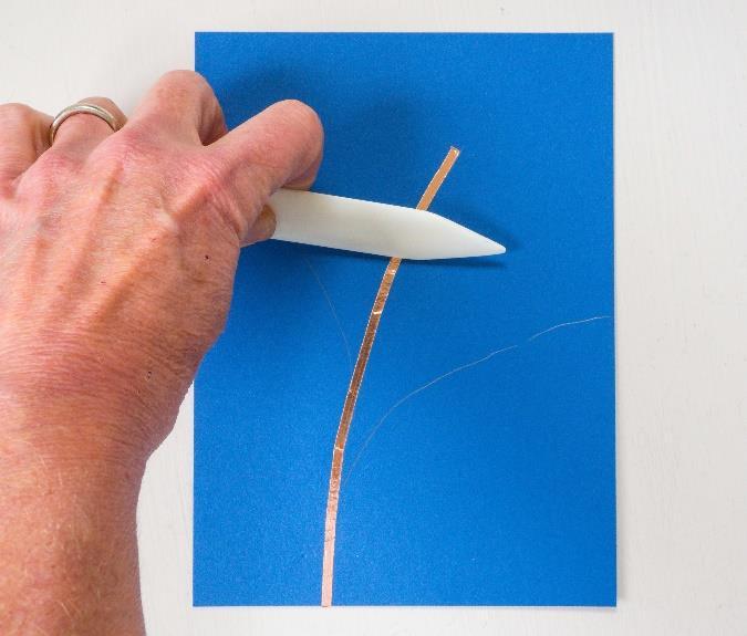 Press any wrinkles out of the tape using a tool with a smooth flat edge.