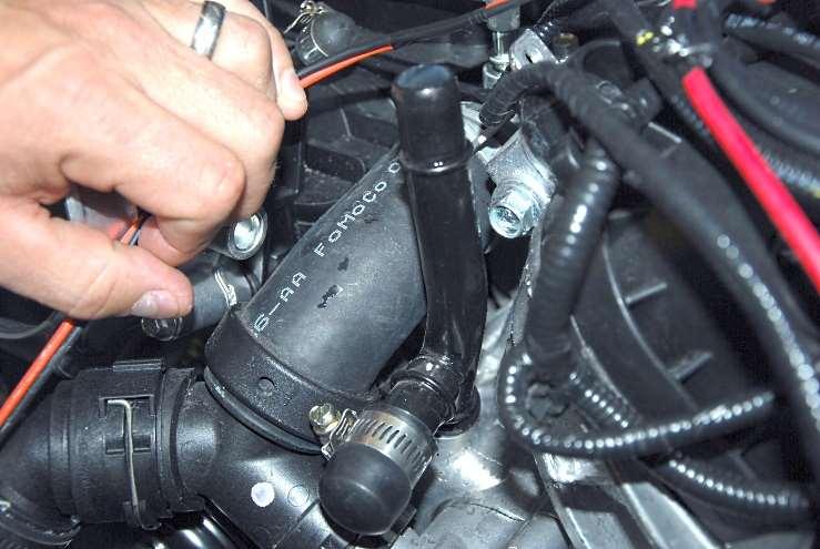 Push the bypass caps onto the lower tube to the left of the throttle body and hose