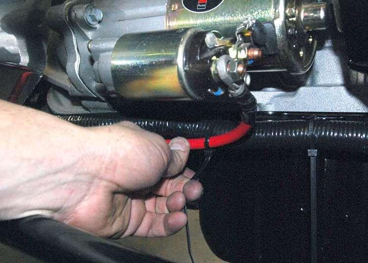 Run the battery cable forward along the transmission
