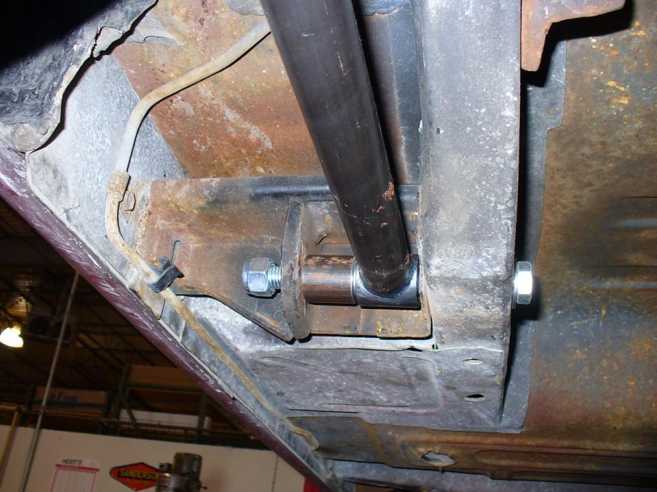 Drill the existing front lower leaf spring holes out to 5/8" diameter and install the lower (long) links with the adjusters to the rear, using the 5/8 x 7" bolts, spacers and nylock