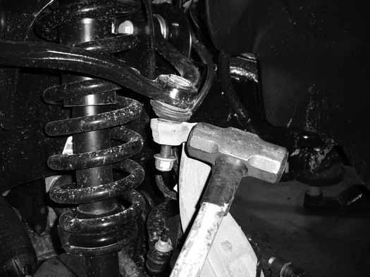 Remove the upper ball joint and the strut-to-lower control arm bolt. Swing the knuckle/lower control arm down to remove the CV shaft from the hub. Retain ball joint nut and strut bolt. 19.