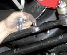 (See Photo # 25) Photo # 23 Photo # 24 30. Remove the OEM steering stabilizer & OEM steering stabilizer bracket from the cross member using a 18mm socket.